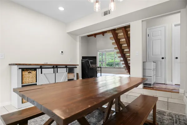 a dining room with furniture and window