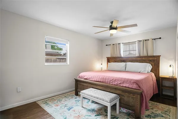 a bedroom with a bed and a window