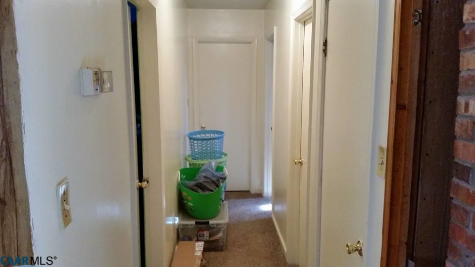 385 Fredericks Hall Road Bumpass, VA 23024 - Photo 13 of 27 a view of a hallway with a potted plant
