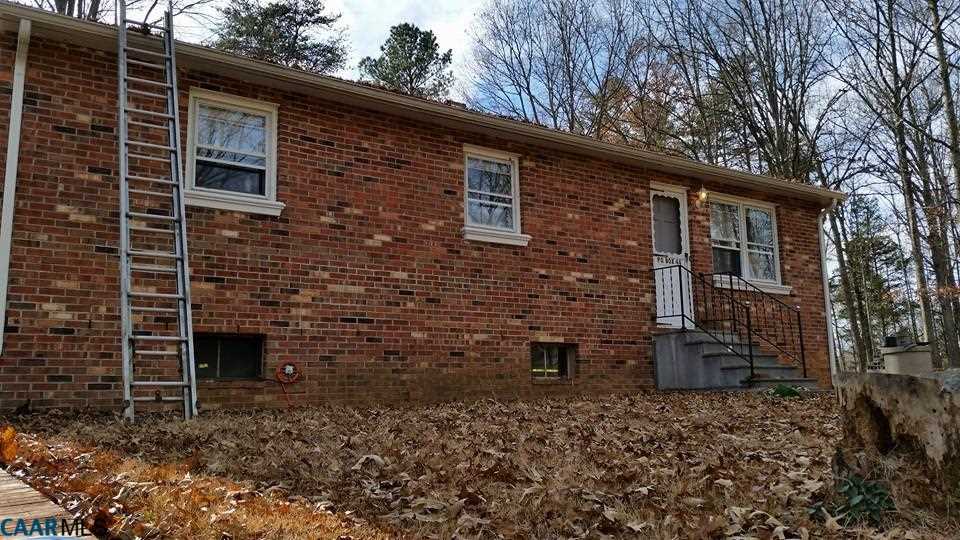 385 Fredericks Hall Road Bumpass, VA 23024 - Photo 25 of 27 a brick building with a window and wooden fence
