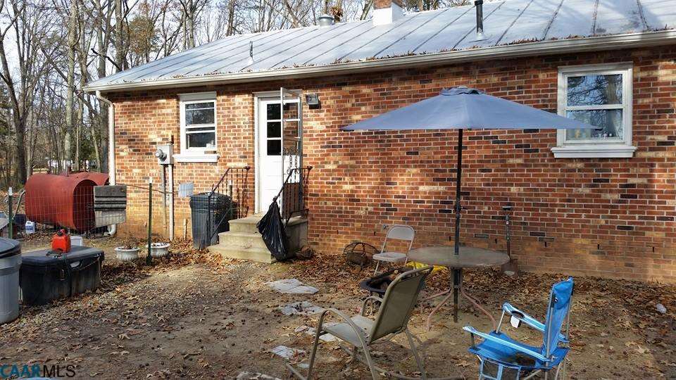 385 Fredericks Hall Road Bumpass, VA 23024 - Photo 3 of 27 a backyard of a house with sofas
