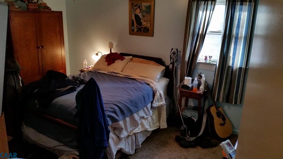 385 Fredericks Hall Road Bumpass, VA 23024 - Photo 5 of 27 a bedroom with a bed and a mirror