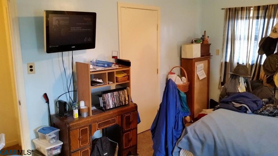 385 Fredericks Hall Road Bumpass, VA 23024 - Photo 6 of 27 a view of walk in closet with clothes and shoes