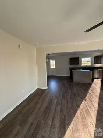a view of empty room with wooden floor and fireplace