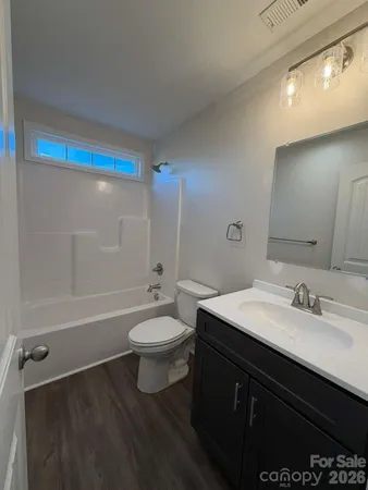 a bathroom with a double vanity sink toilet and shower