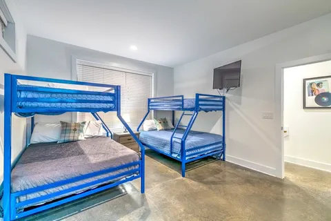 a bedroom with a large bed and a chandelier