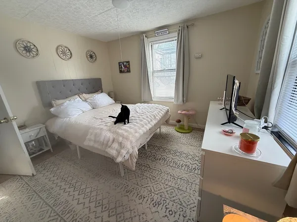a bed sitting in a bedroom next to a window