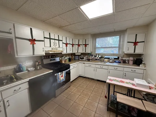 a kitchen with a sink appliances cabinets and a counter top space