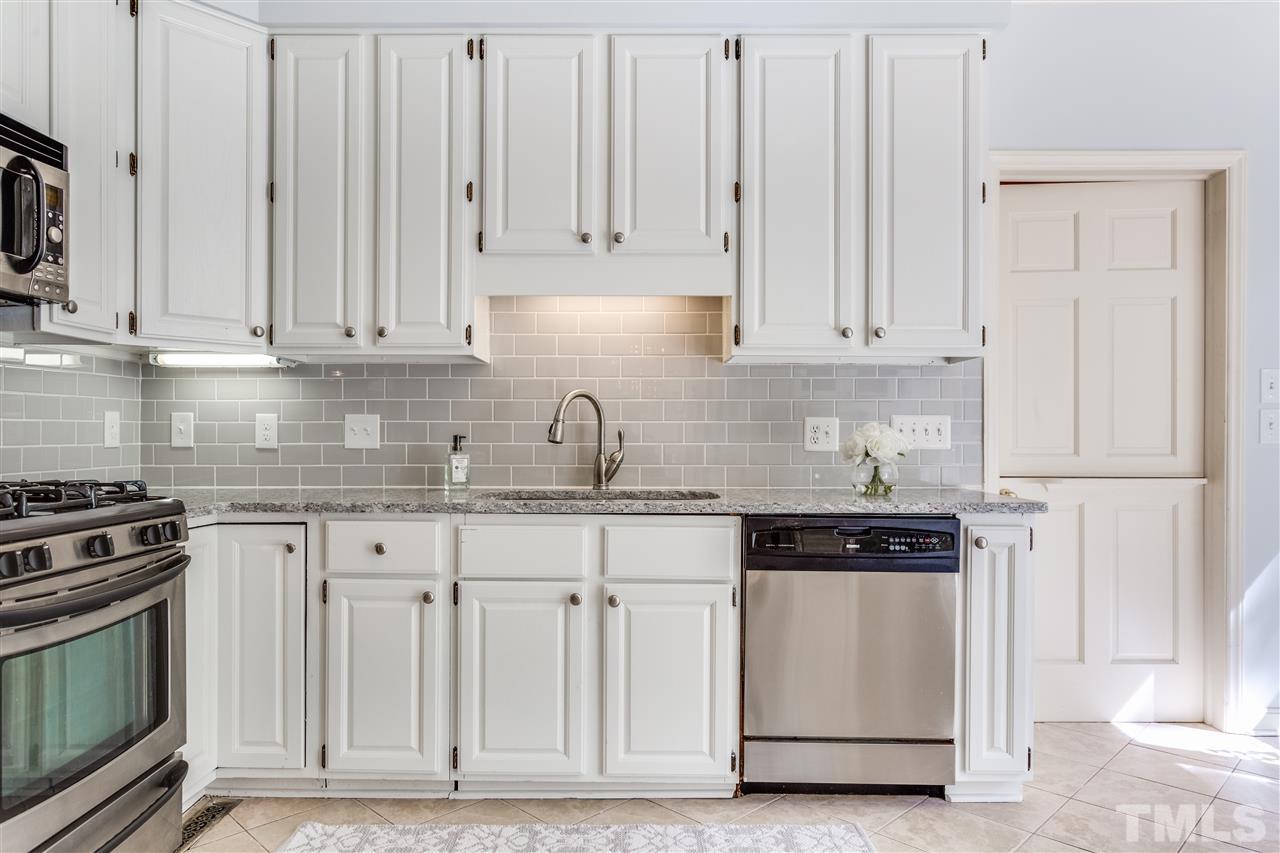 2915 Buckingham Road Durham, NC 27707 - Photo 11 of 25 a kitchen with granite countertop white cabinets and stainless steel appliances