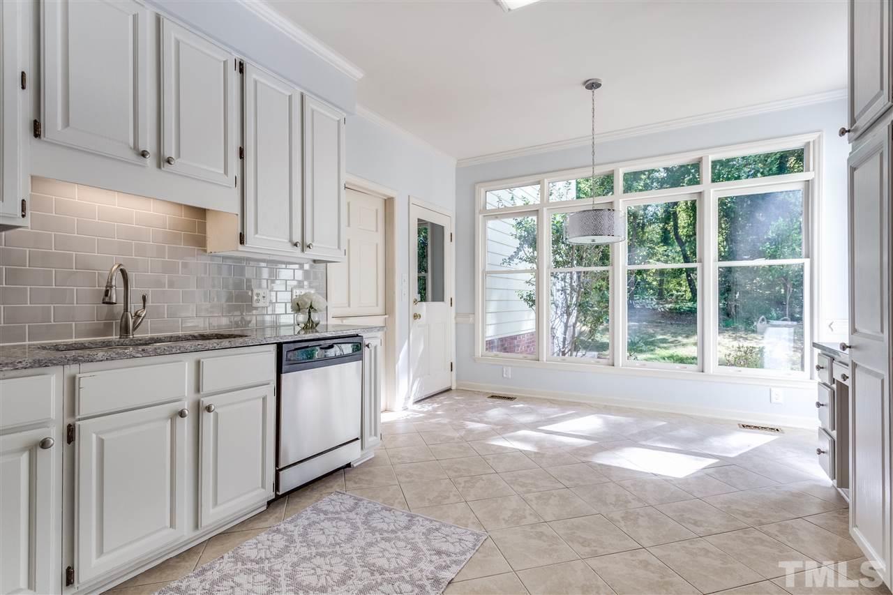 2915 Buckingham Road Durham, NC 27707 - Photo 12 of 25 a open kitchen with granite countertop a stove a sink and white cabinets