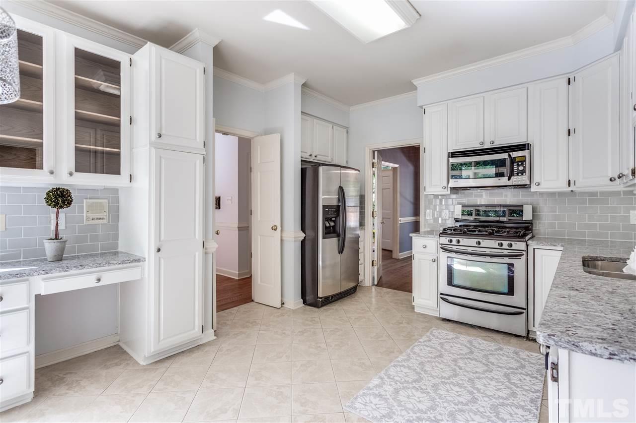 2915 Buckingham Road Durham, NC 27707 - Photo 13 of 25 a kitchen with stainless steel appliances granite countertop a refrigerator stove and sink