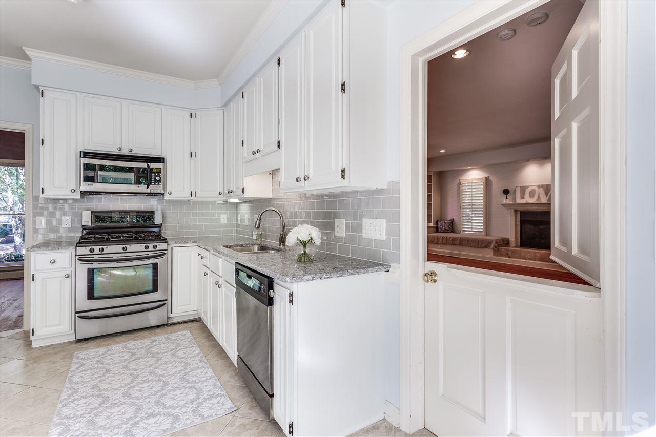 2915 Buckingham Road Durham, NC 27707 - Photo 14 of 25 a kitchen with stainless steel appliances granite countertop a stove and a refrigerator