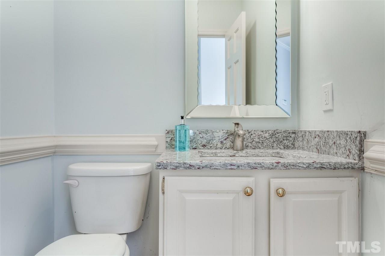 2915 Buckingham Road Durham, NC 27707 - Photo 16 of 25 a bathroom with a granite countertop toilet sink and mirror