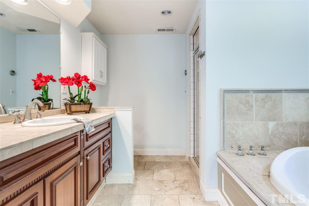 2915 Buckingham Road Durham, NC 27707 - Photo 19 of 25 a bath room with a sink and a mirror