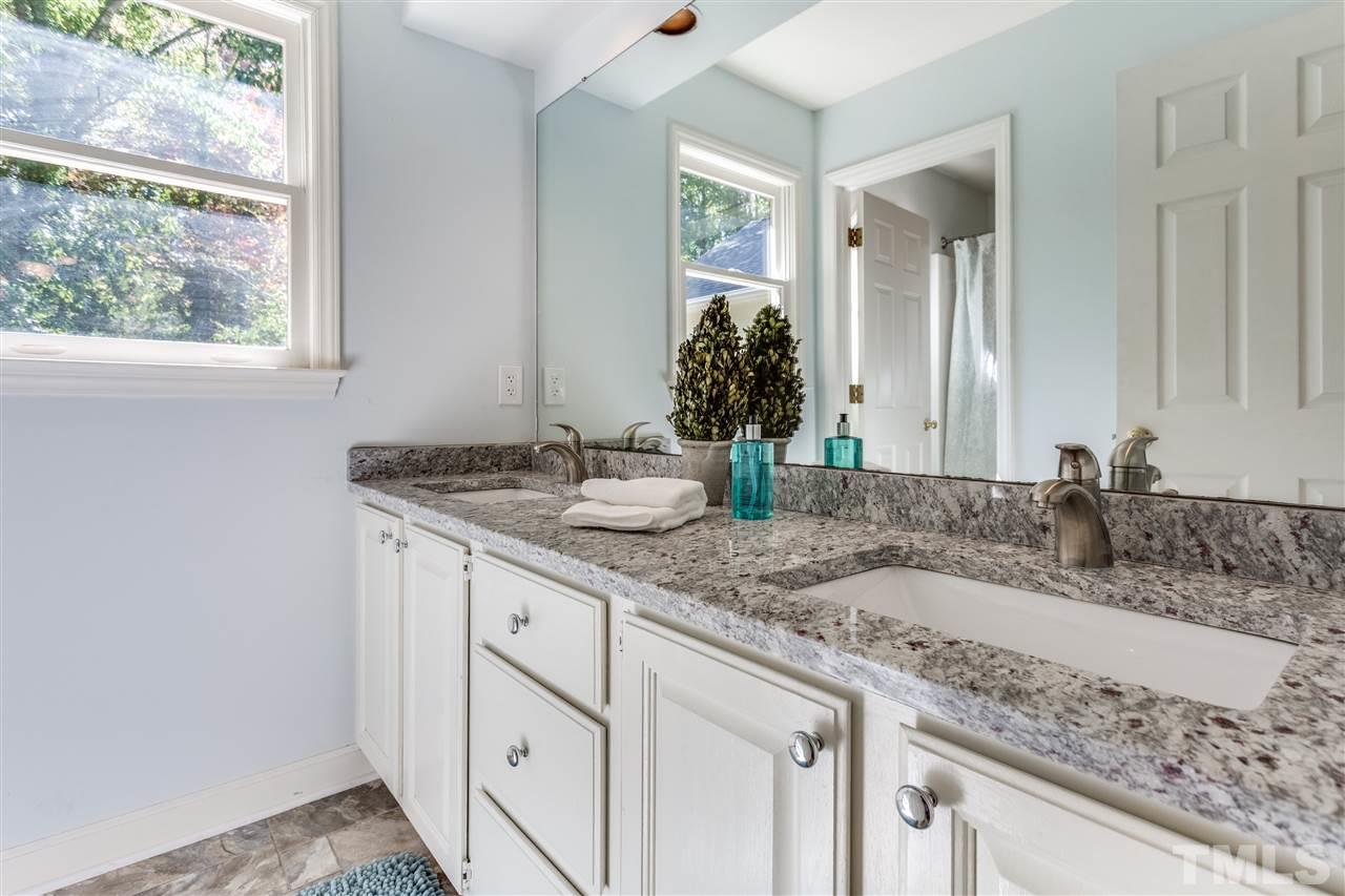 2915 Buckingham Road Durham, NC 27707 - Photo 21 of 25 a bathroom with a granite countertop sink and a mirror