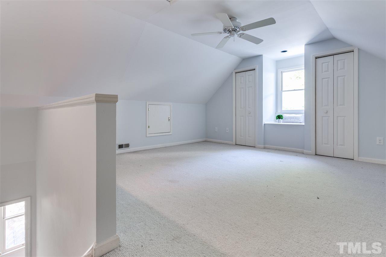 2915 Buckingham Road Durham, NC 27707 - Photo 23 of 25 an empty room with chandelier fan and windows