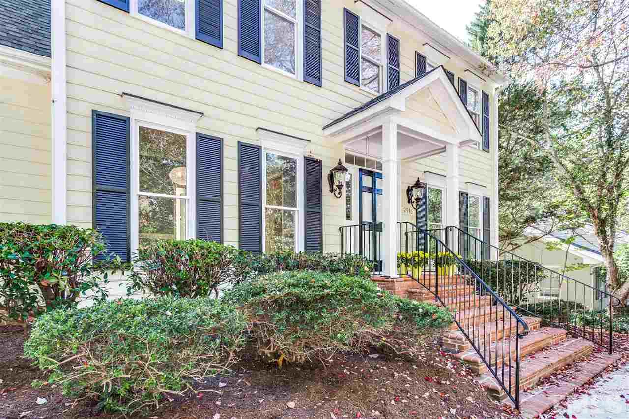 2915 Buckingham Road Durham, NC 27707 - Photo 4 of 25 a view of a brick house with large windows and plants