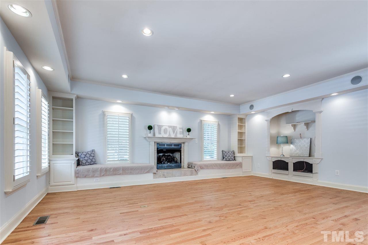 2915 Buckingham Road Durham, NC 27707 - Photo 8 of 25 an empty room with fireplace and windows