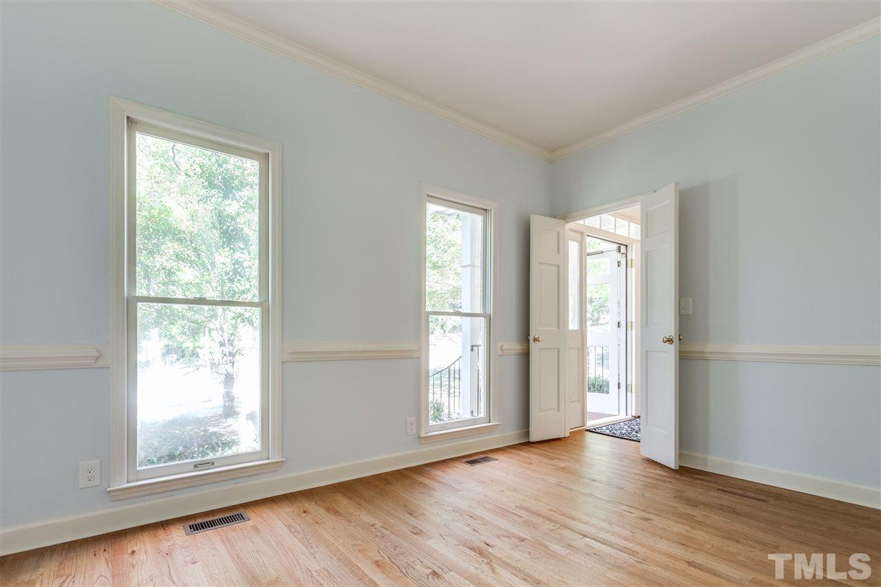2915 Buckingham Road Durham, NC 27707 - Photo 10 of 25 a view of an empty room with wooden floor and a window