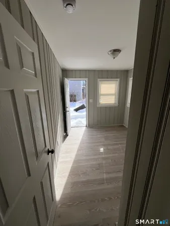a view of a hallway view with wooden floor and staircase