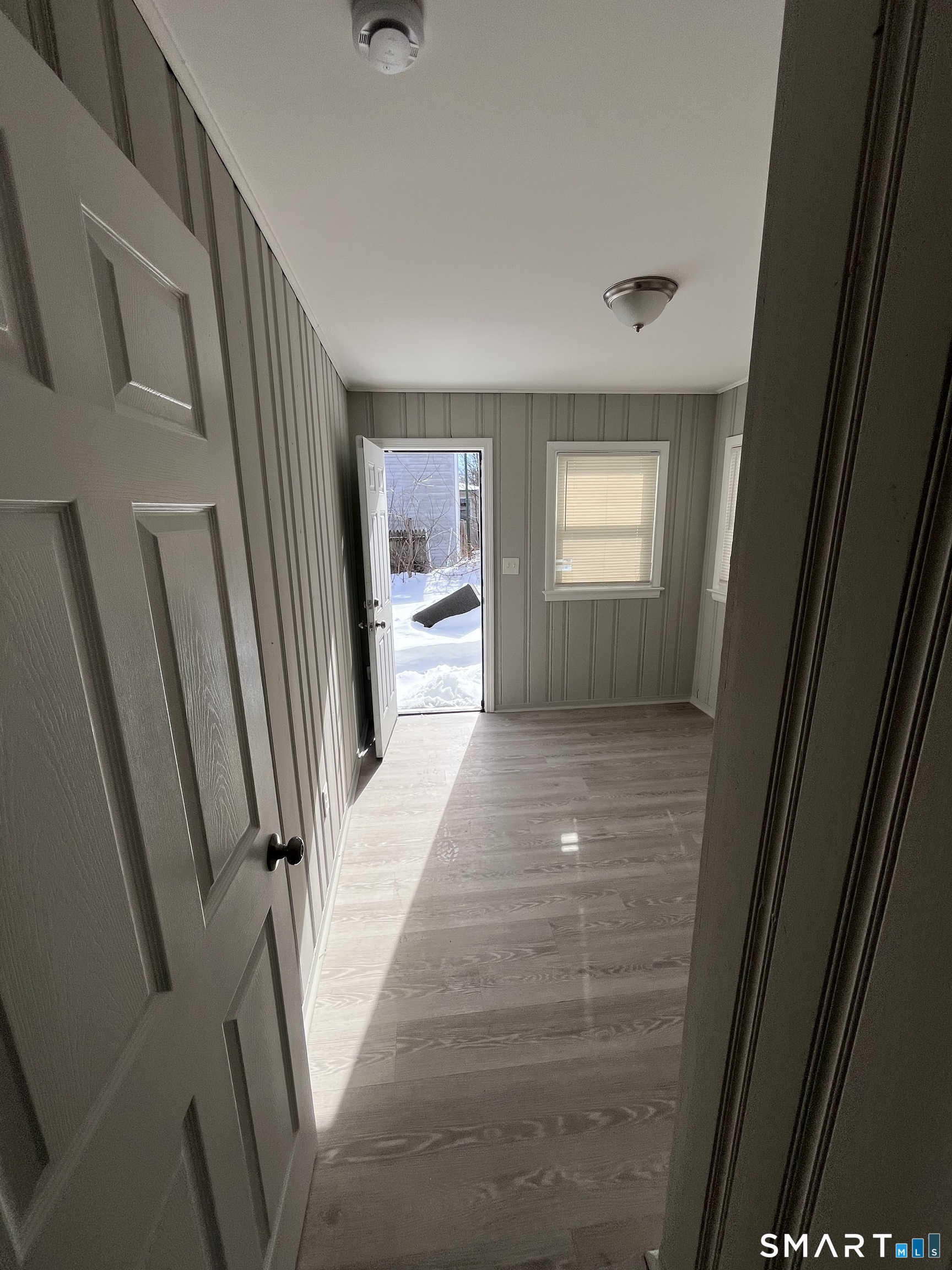 144 Clark Street New Britain, CT 06051 - Photo 3 of 14 a view of a hallway view with wooden floor and staircase