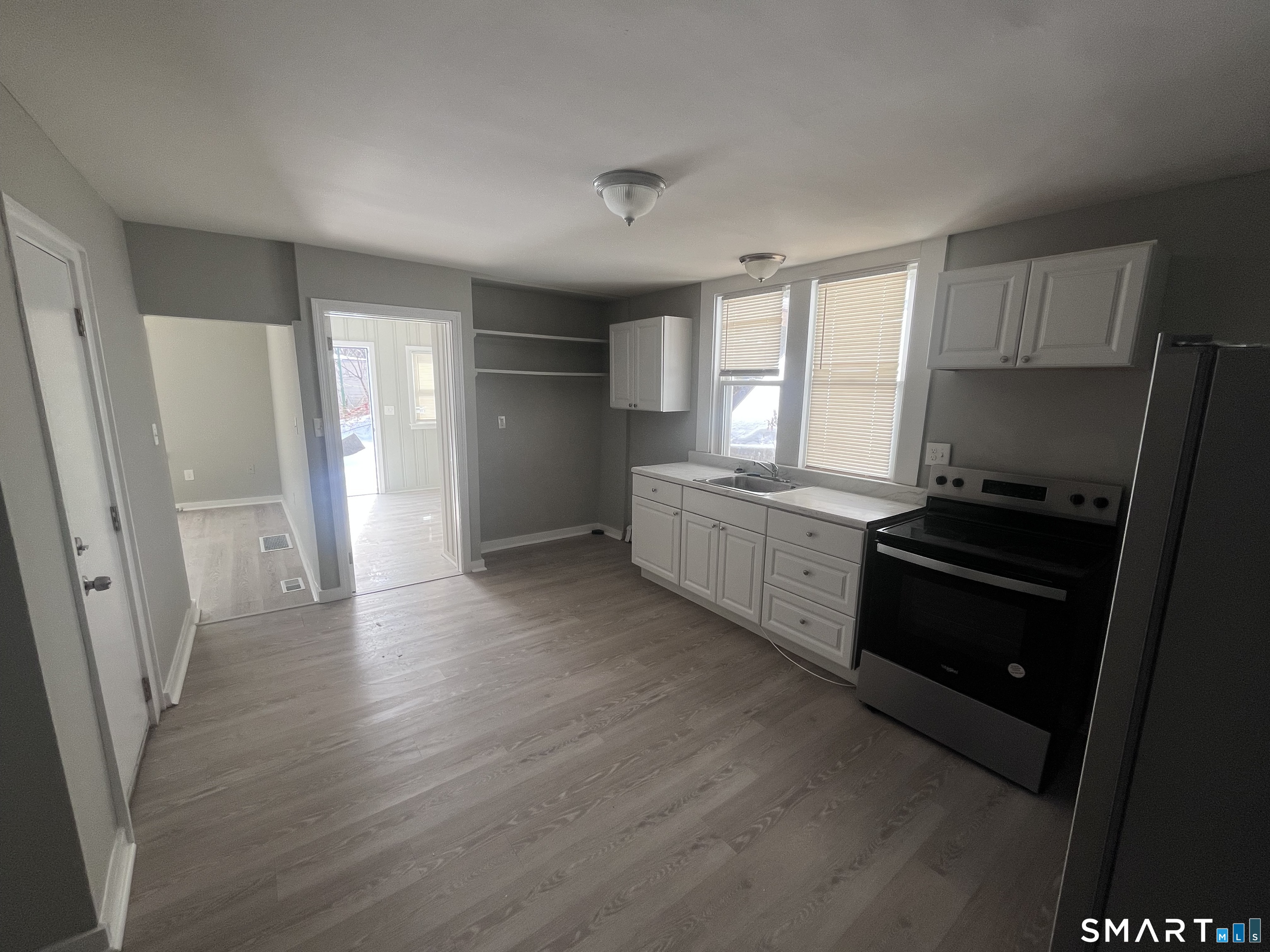 144 Clark Street New Britain, CT 06051 - Photo 5 of 14 a kitchen with a refrigerator and a stove top oven