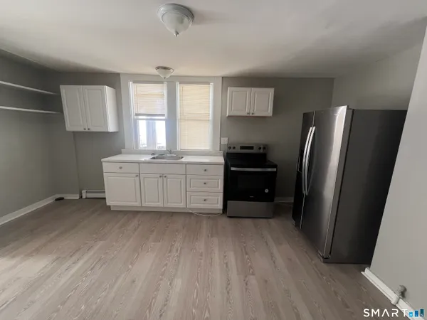 a kitchen with stainless steel appliances a refrigerator sink and cabinets