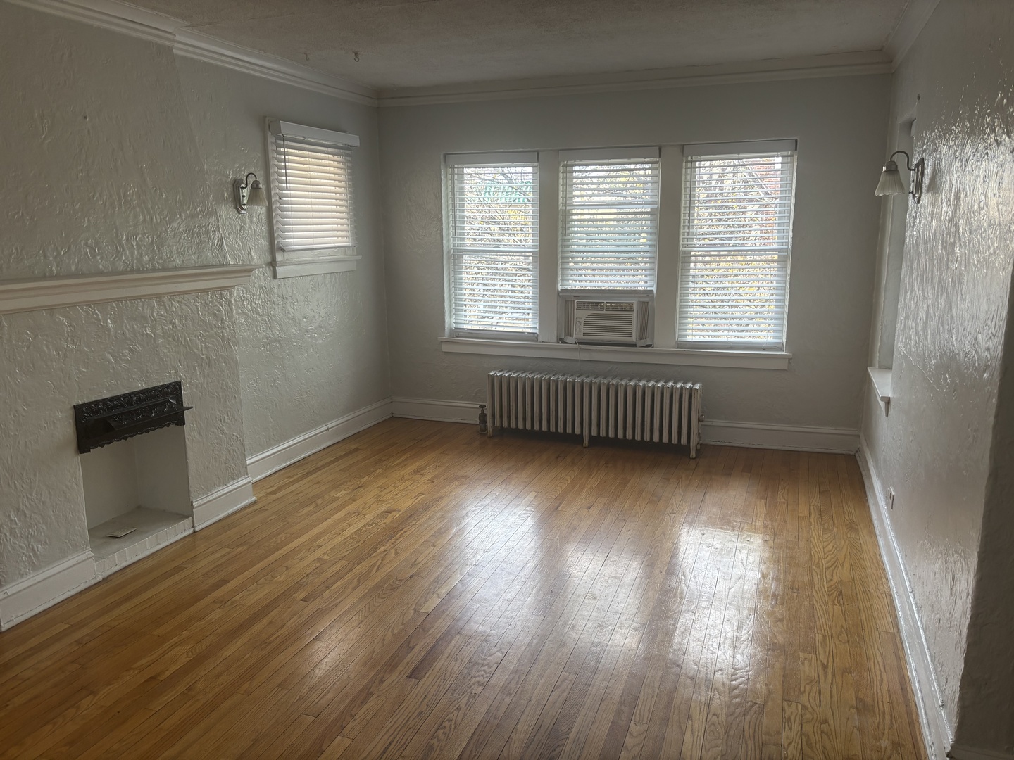 5440 North Campbell Avenue, Unit 3F Chicago, IL 60625 - Photo 2 of 7 an empty room with wooden floor and windows