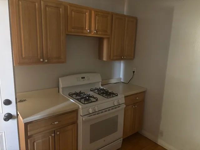 a white stove top oven sitting inside of a kitchen