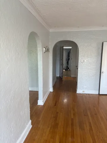 a view of a hallway with wooden floor