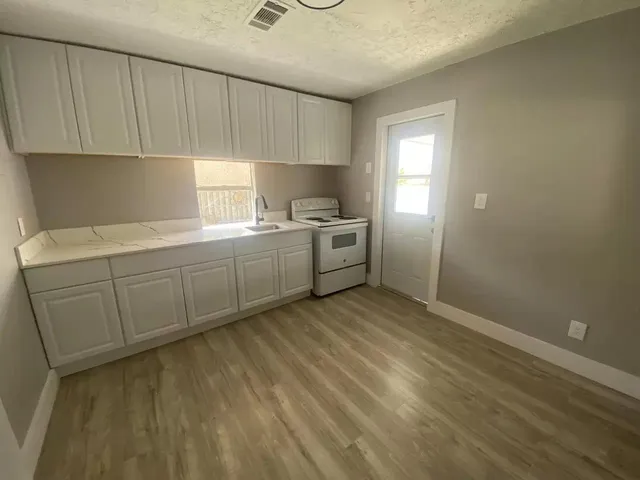 a kitchen with a sink and cabinets