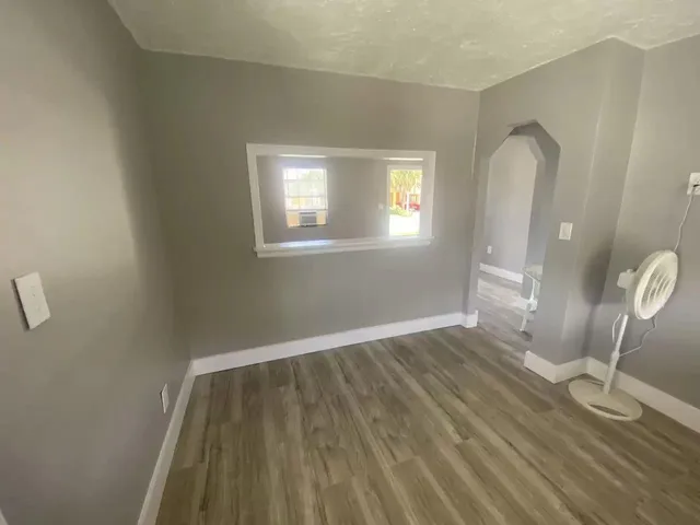 a view of a room with wooden floor and glass door