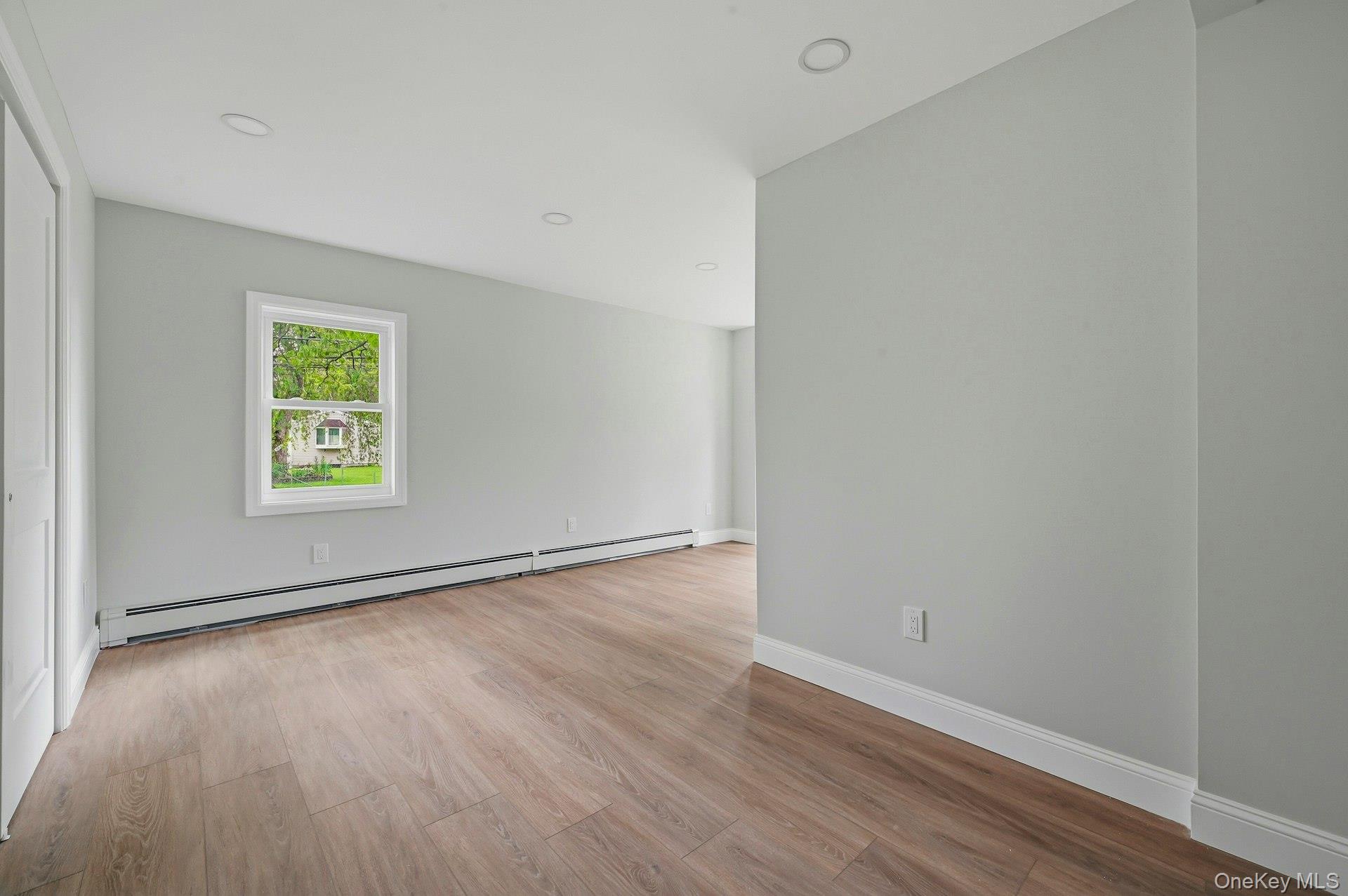 101 Rustic Road Centereach, NY 11720 - Photo 30 of 42 a view of an empty room with wooden floor and a window