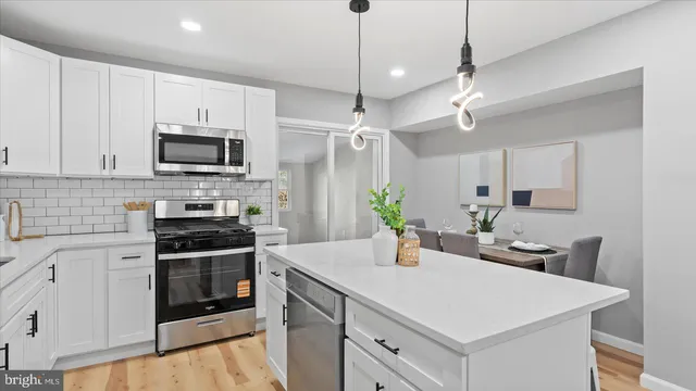 a kitchen with a sink a stove and microwave