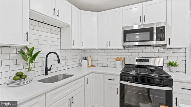 a kitchen with a sink and a stove top oven