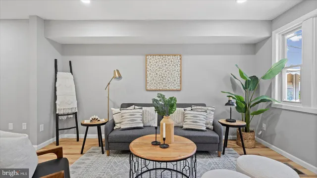 a living room with furniture a table and a potted plant