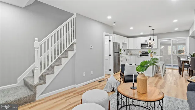 a living room with furniture kitchen view and a dining table