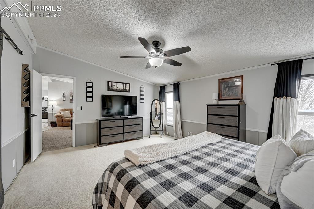 237 9th Street Penrose, CO 81240 - Photo 14 of 24 a bedroom with a bed and a chandelier