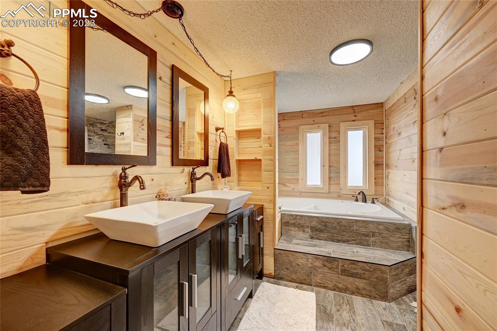 237 9th Street Penrose, CO 81240 - Photo 15 of 24 a bathroom with a sink double vanity and a mirror