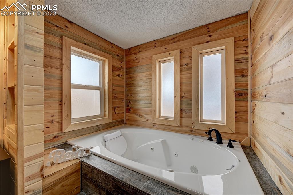 237 9th Street Penrose, CO 81240 - Photo 16 of 24 a bathroom with a bathtub and a shower