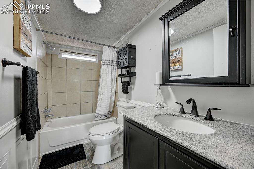 237 9th Street Penrose, CO 81240 - Photo 19 of 24 a bathroom with a granite countertop sink toilet and shower