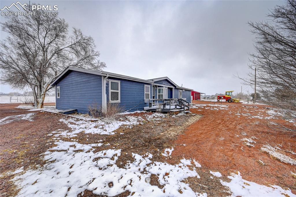 237 9th Street Penrose, CO 81240 - Photo 2 of 24 a wooden bench sitting in front of a house