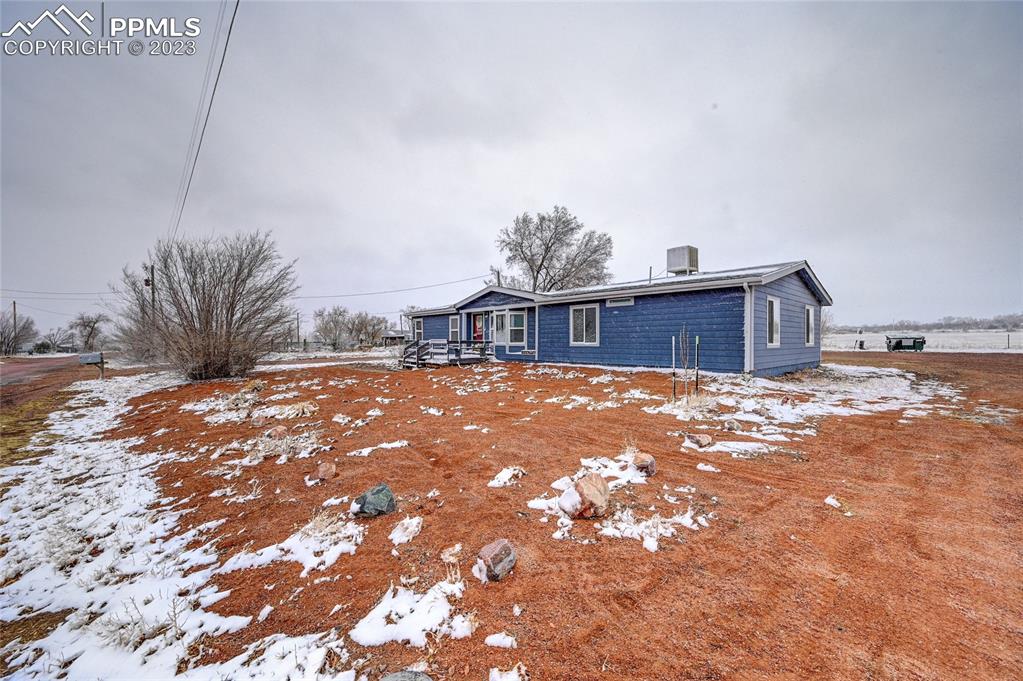 237 9th Street Penrose, CO 81240 - Photo 3 of 24 a view of a house with a snow on the road