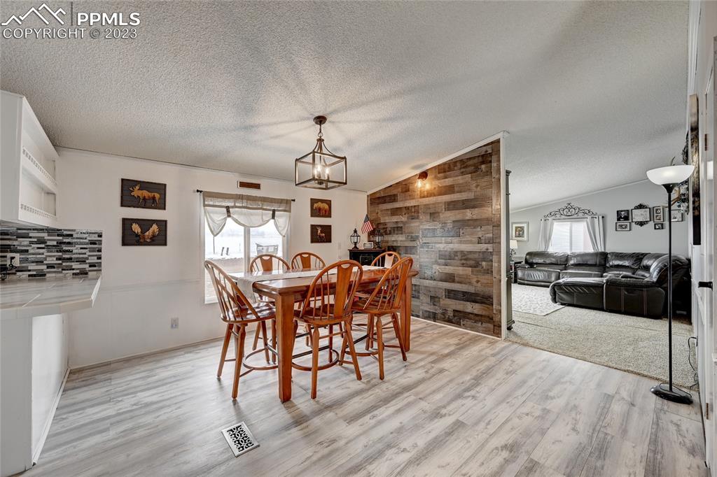 237 9th Street Penrose, CO 81240 - Photo 6 of 24 a dining room with furniture and wooden floor