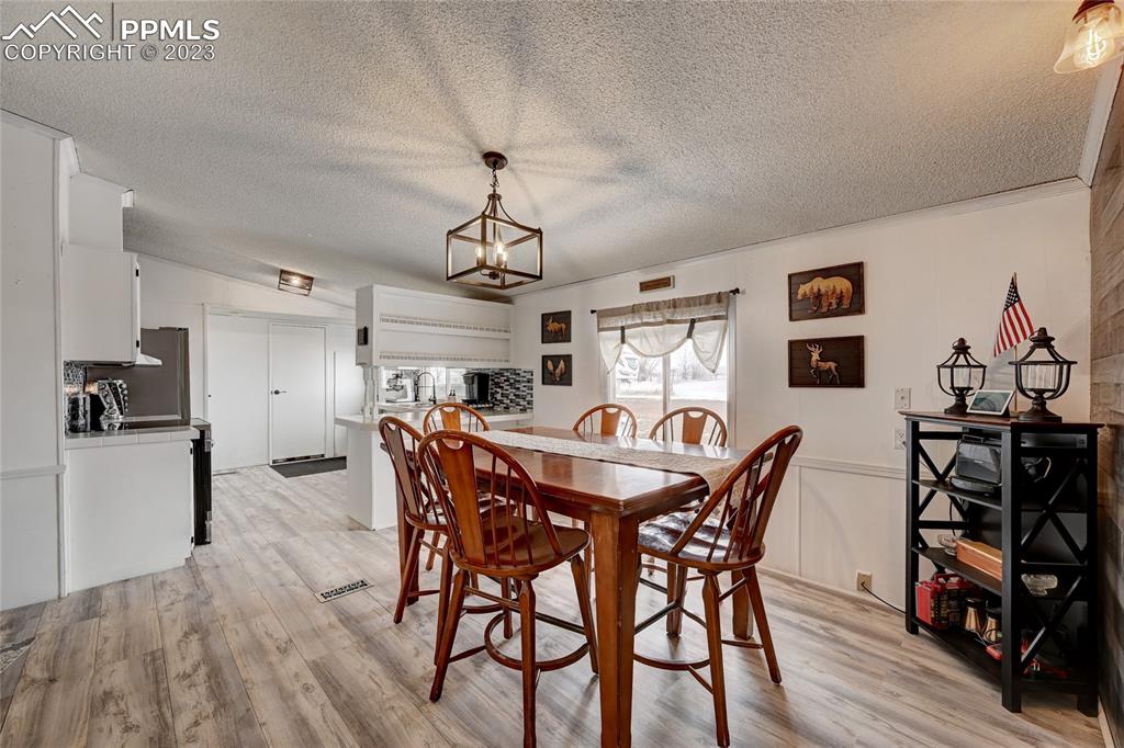 237 9th Street Penrose, CO 81240 - Photo 7 of 24 a view of a dining room with furniture and wooden floor