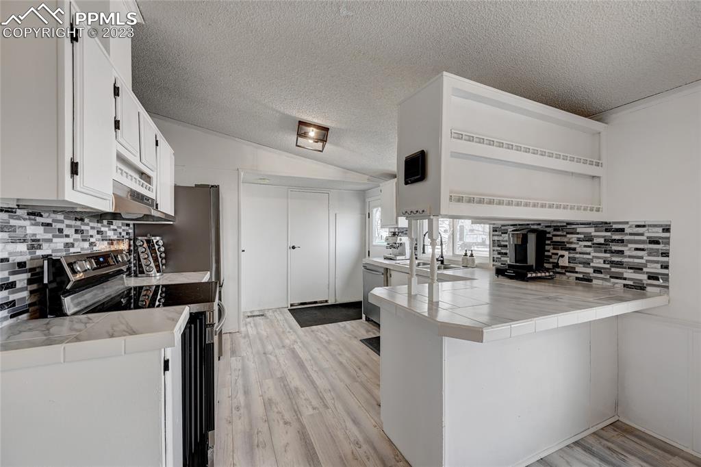 237 9th Street Penrose, CO 81240 - Photo 8 of 24 a kitchen with refrigerator and cabinets