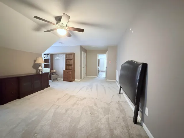 a view of a livingroom with furniture and a ceiling fan