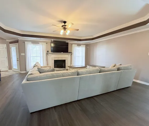 a living room with furniture and flat screen tv