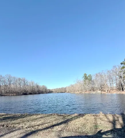 a view of a white house with swimming pool in front of it