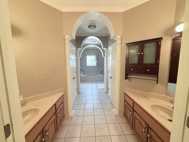 a bathroom with a sink a mirror and a shower